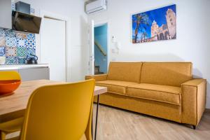 a living room with a couch and a table at Incao Holiday Candeloro House in Cefalù