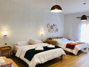 a bedroom with two beds and a window at Foleza - Bed and breakfast in Vlorë