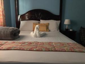 a stuffed animal sitting on top of a bed at Raine’s studio and more in Kingston