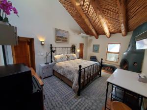 a bedroom with a bed with a wooden ceiling at Casas de Suenos Old Town Historic Inn, Ascend Hotel Collection in Albuquerque +37 photos