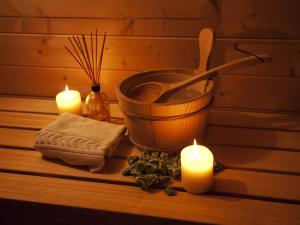 a group of candles and a bath tub with a bowl and a wooden spoon at Cerro Mar Atlantico & Cerro Mar Garden in Albufeira