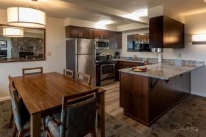 a kitchen with a wooden table and a kitchen with a refrigerator at Driftwood Shores Resort in Florence