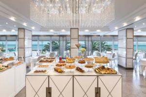 a buffet in a hotel with food on a table at Hotel Tiffany's in Riccione