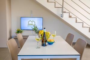 a dining room with a table with wine glasses at Residence Salinelle Beach Villa Lipari 1 in Lascari