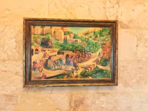 a painting on a wall of a painting of a village at Gazel Butik Otel in Urfa