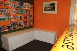 a book shelf in a book store with a bench at Manly Bunkhouse in Sydney +143 photos