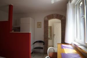 a kitchen with a table and a chair in a room at Apartments Ginkgo in Banjole