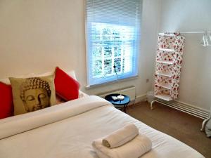 a bedroom with a bed with a statue of a head at Charming Cottage & Garden - central Brighton! in Brighton & Hove