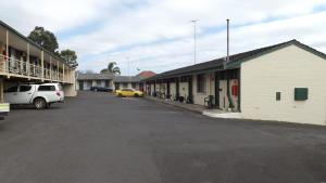 an empty parking lot in front of a building at Collie Motel in Collie