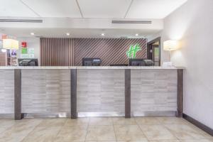 a kitchen with a large counter top and a large mirror at Holiday Inn Miami International Airport, an IHG Hotel in Miami