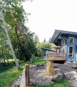 a blue house with a black roof on a yard at Hoh Valley Cabins in Forks