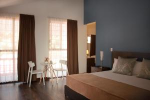 a bedroom with a bed and a table with chairs at VIAMONTE House Boutique in León