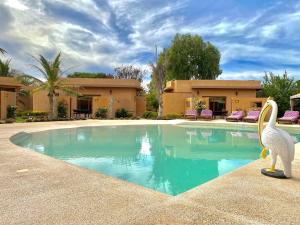 a statue of a pelican standing next to a swimming pool at Hôtel La Belle Etoile & SPA in Saly Portudal