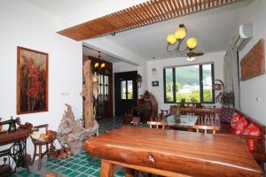 a living room with a wooden table and chairs at Mandheling B&B in Ji'an