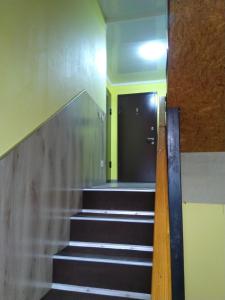 a hallway with stairs leading up to a stairwell at Mini Hotel Oliva in Svyatogorsk