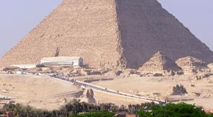 a view of the pyramids of giza with a bus at Nine Pyramids View Hotel in Cairo