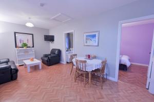 a living room with a table and chairs at 10minDriveCliffsOfMoher-Cozy2Br-Parking-WiFi in Lahinch
