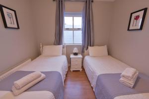 Postel nebo postele na pokoji v ubytování Ocean Breeze Apartment