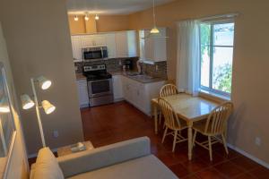 a kitchen with a table and a dining room at Sandy Beach Suites in Osoyoos