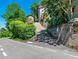 an empty road next to a wall and a building at Belvilla by OYO Nord in Castellarano