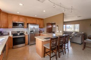 a kitchen with wooden cabinets and stainless steel appliances at Sunlight Retreat in Twentynine Palms