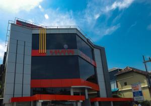 a building with a sign on the side of it at KALATHIL TOURIST HOME in Kunnamkulam