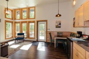 a kitchen with a table and a dining room at Hoh Valley Cabins in Forks