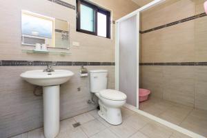 a bathroom with a toilet and a sink at 曉翠軒親子民宿 in Wujie