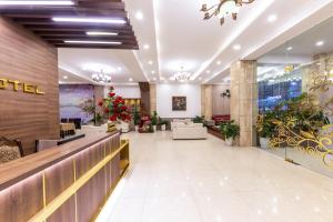 a lobby of a hotel with a christmas tree at Mai Thang Hotel Da Lat in Da Lat