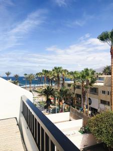 a view of the beach from the balcony of a resort at LUX&2Jacuzzi. NEW! Golden Mile Las Americas, Parque Santiago 2. Pool heated Sea water 2 BDR in Playa de las Americas