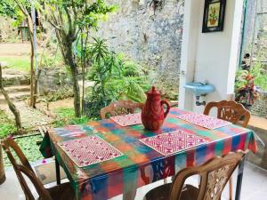 a table with a vase sitting on top of it at Kandy IVY Banks Holiday Resort in Kandy +55 photos