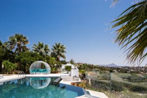 a swimming pool in a villa with palm trees at Paul's Mansion in Chania