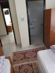a bedroom with a bathroom with a shower and a bed at Hasyurt Hotel in Finike