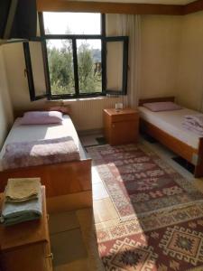 a room with two beds and a window at Hasyurt Hotel in Finike