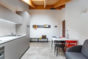 a kitchen and living room with a table and chairs at Dreams Hotel Residenza Pianell 10 in Milan