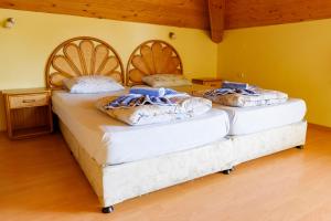 two twin beds in a room with yellow walls at Complex Maxim in Varna City