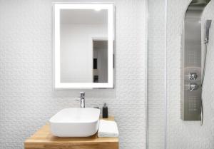 a bathroom with a white sink and a mirror at Feel like an Emperor Apartments in Split