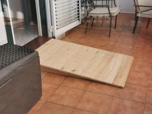 a wooden bench sitting on a tiled floor at La Casa del Sol, Abades in Abades