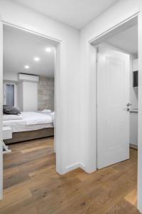 a bedroom with a bed and a white door at Feel like an Emperor Apartments in Split