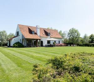 クノック・ヘイストにある't Klein Keuvelhofの広い芝生の大白い家