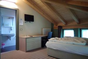 A bed or beds in a room at Chalet Maso Fradea Family Resort