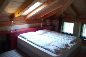 A bed or beds in a room at Chalet Maso Fradea Family Resort