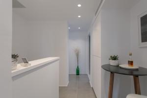 a kitchen with a table and a white wall at Vorta Naxos in Naxos Chora