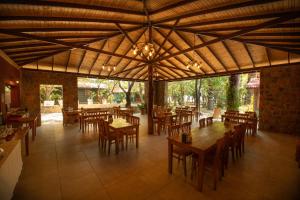an empty restaurant with wooden tables and chairs at Eden Bungalows and Beach in Köyceğiz