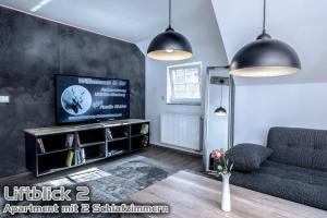 a living room with a television and a couch at Ferienwohnungen "Liftblick 2 oder 3" im Kurort Altenberg in Kurort Altenberg