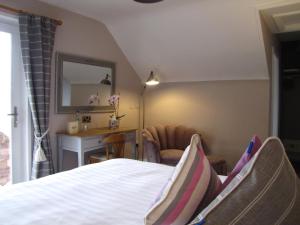 a bedroom with a bed and a desk and a mirror at Rolfs Country House in Baltimore