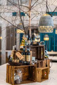 a wooden table topped with bottles of wine at Strandhotel Balka Søbad in Neksø