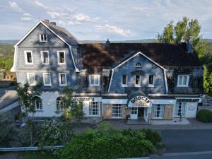 an old house with a gray roof at Hotel Haus Rödgen in Wilnsdorf