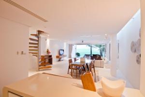 a dining room and living room with a table and chairs at Panu Luxury Apartment in Bophut