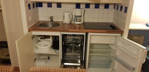 a small kitchen with a sink and a dishwasher at Lacanau golf in Lacanau